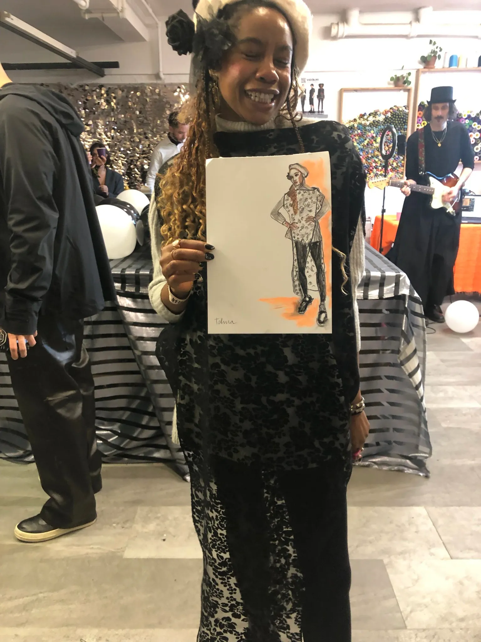 A guest holding the portrait Tracey drew live at an event.