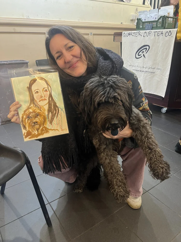 Smiling woman with dog and watercolour portrait.