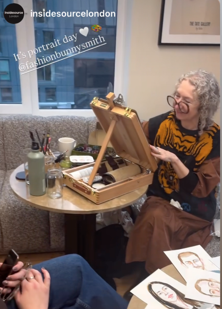 Woman in tiger-print top with art box.