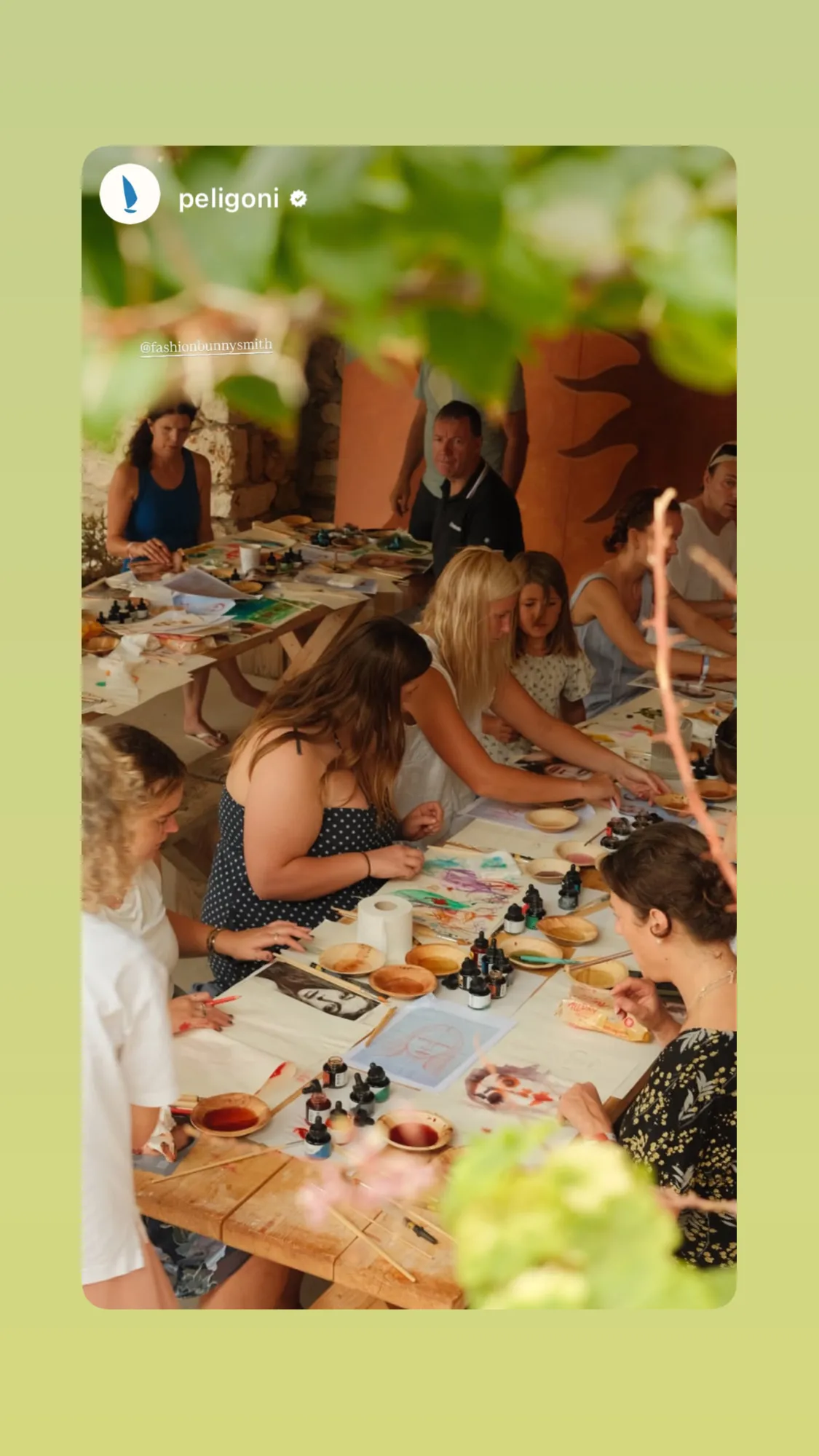 Guests painting at long wooden tables during an Inky Faces workshop at Peligoni, Greece